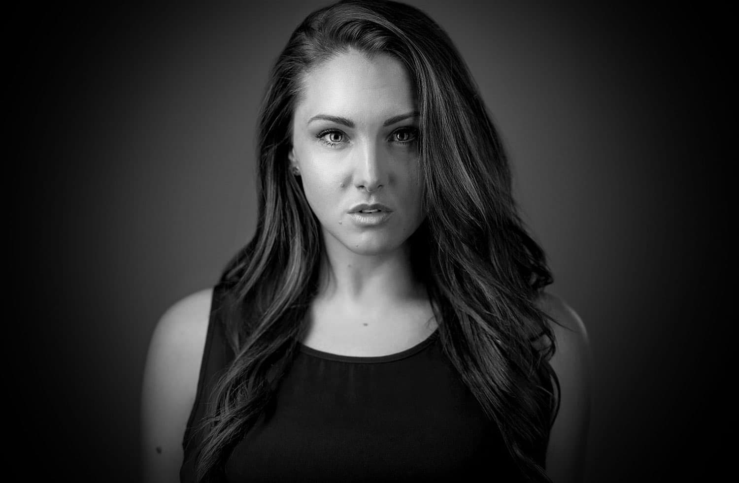 Black and white chest height portrait of Emily Coatman